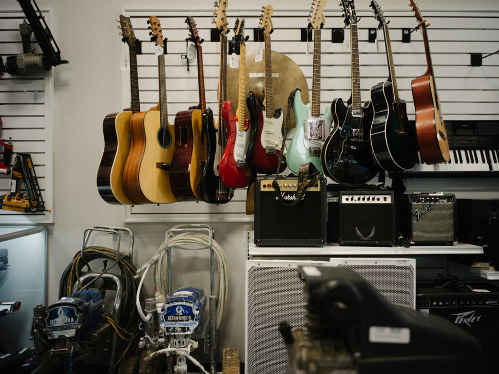 Variety of guitars displayed on wall